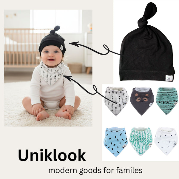 Baby wearing a black knot hat with Uniklook branding, surrounded by baby products like bibs and bandannas.