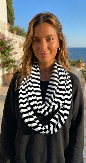 Woman wearing a black and white striped scarf with a scenic background