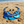 Charger l'image dans la galerie, Blue beaded necklace and matching drop earrings displayed on a sandy beach with the ocean in the background.
