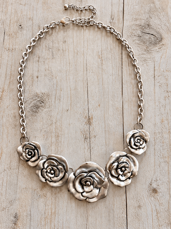 Burnished silver five rose necklace on pale rustic barn wood, individual product photo