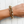 Load image into Gallery viewer, Gold chain bracelet on a wrist against a white wooden background
