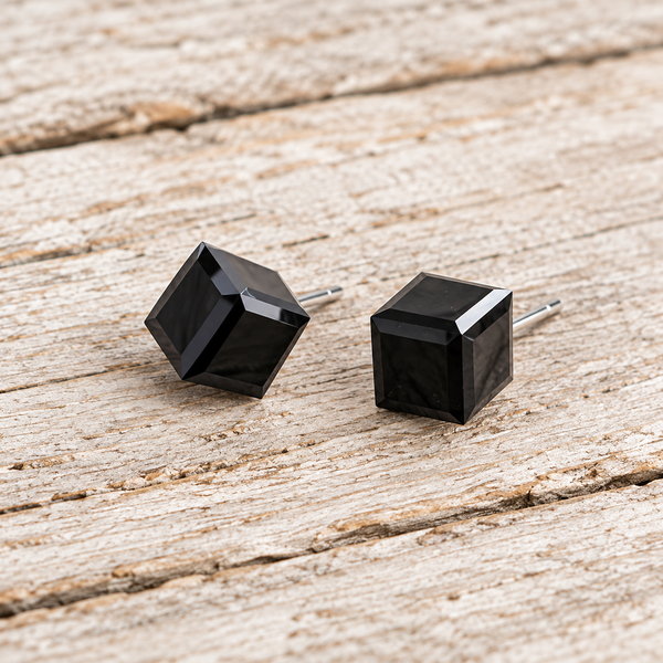 Black cube cubic zirconia stud earrings on pale barn wood