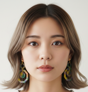 Woman wearing earrings with a neutral background