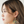 Load image into Gallery viewer, Woman wearing colorful earrings against a plain background
