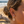 Charger l'image dans la galerie, Close-up of a person's ear with earrings on a beach.

