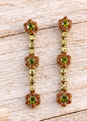 Floral crystal earrings on pale barn wood