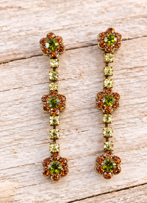 Floral crystal earrings on pale barn wood
