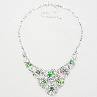 Green crystal statement necklace laid flat on white background