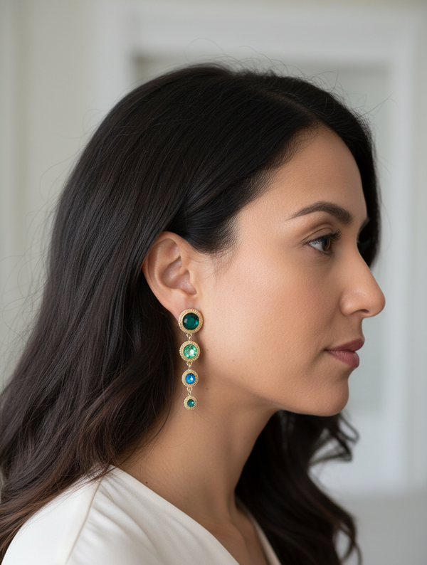 Woman wearing a pair of earrings with a neutral background