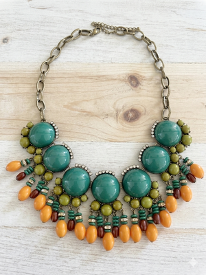 Colorful beaded necklace on a wooden surface