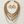 Load image into Gallery viewer, A gold and silver beaded necklace set with matching teardrop earrings, displayed on a light wood background.
