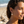 Charger l'image dans la galerie, Woman wearing sun-shaped earrings on a beach
