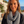 Load image into Gallery viewer, Woman wearing a black and white zigzag scarf with a scenic background
