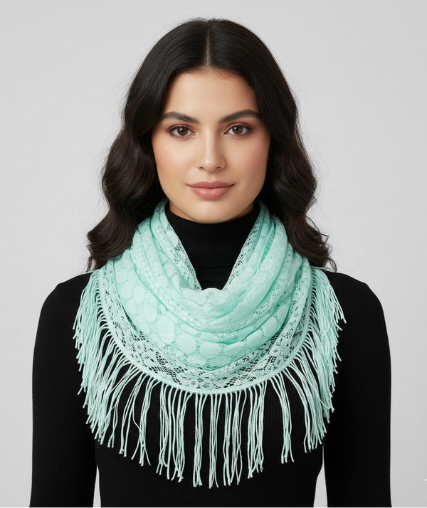Woman wearing a light blue scarf with fringe details on a gray background