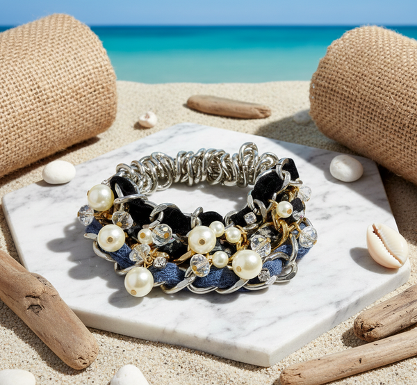 Bracelet with pearls and crystals on a marble slab with beach background