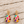 Load image into Gallery viewer, Gold plated multicolor rhinestone teardrop earrings on pale barn wood
