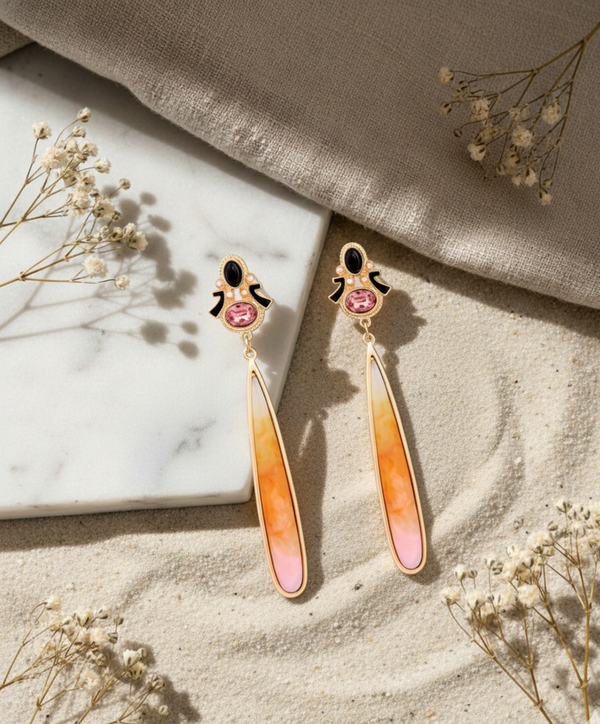 Ombre earrings with pink and orange gradient on a neutral background