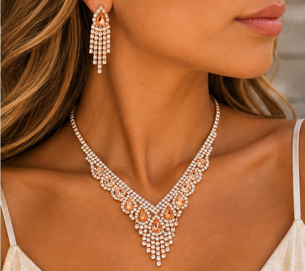 Peach crystal necklace and earrings worn by a model