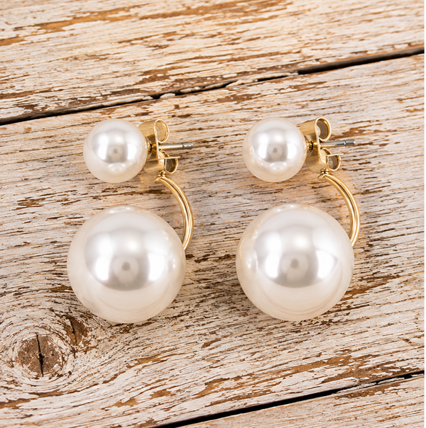 Double faux pearl ear jacket earrings on pale barnwood