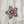 Load image into Gallery viewer, A vintage-style star-shaped brooch featuring an antiqued silver-tone filigree frame and multiple pink marquise and round crystals, shown on a plain white background.
