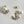 Load image into Gallery viewer, Pair of pearl earrings with gold accents on a light gray background
