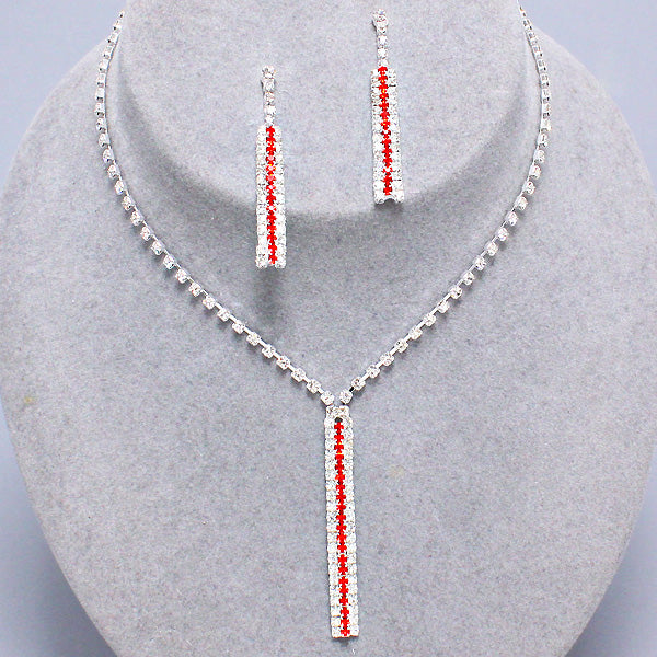 Red and clear rhinestone necklace with matching rectangular drop earrings on grey jewelry display