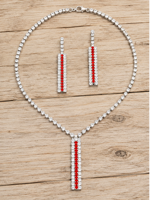 Red and clear crystal necklace and matching earrings on pale rustic wood