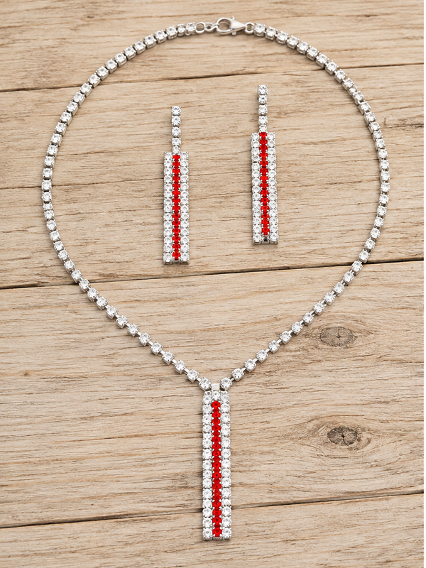 Red and clear crystal necklace and matching earrings on pale rustic wood