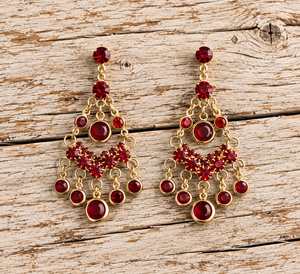 Ruby red rhinestone chandelier earrings on pale barnwood