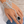 Load image into Gallery viewer, Silver crystal hand chain bracelet with black adjustable ring worn on hand
