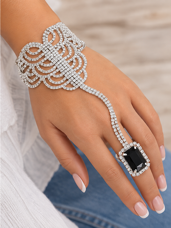 Silver crystal hand chain bracelet with black adjustable ring worn on hand