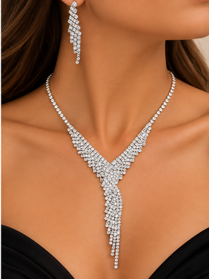 Silver crystal cascading statement necklace and matching earrings worn by a woman