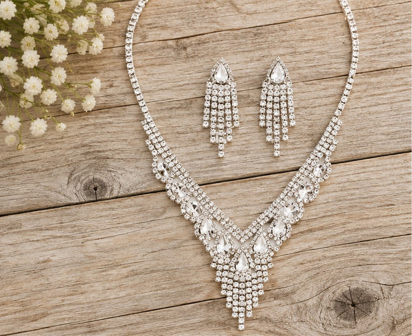 Silver clear crystal necklace and earrings on pale barn wood