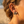 Charger l'image dans la galerie, Close-up of a person wearing earrings with a beach background
