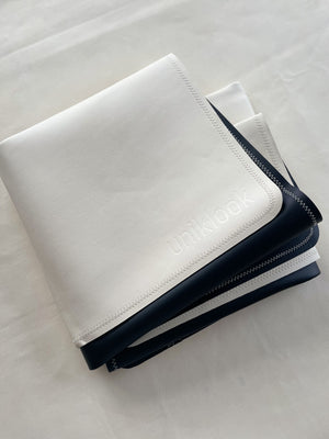 The med mat off white and black fold in four.