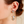 Load image into Gallery viewer, Triangle-shaped earrings with gemstones worn by a person
