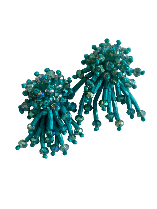 Pair of teal beaded earrings on a light background