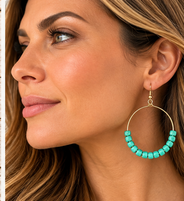 Woman wearing turquoise beaded gold-tone hoop earrings, 2.75 inch drop