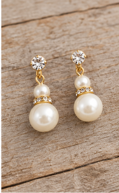 Cream pearl drop earrings close up