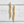 Load image into Gallery viewer, Gold beaded statement earrings on a light wooden surface
