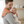 Load image into Gallery viewer, Man holding a baby wrapped in an orange wrap in a room with a crib and window blinds.
