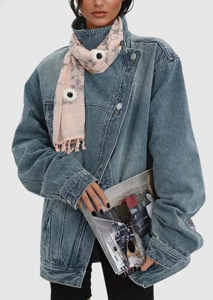 Person wearing a denim jacket and holding a clutch with a white background