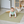 Load image into Gallery viewer, Baby crawling on a green mat in a room with furniture and toys.

