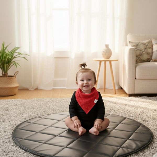 Baby sitting on a round mat in a living room
