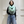 Load image into Gallery viewer, Person wearing a light blue scarf with white fringe in front of a white paneled wall.
