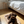 Charger l'image dans la galerie, Dog lying on a pet bed in a bedroom with a bed and nightstand in the background.
