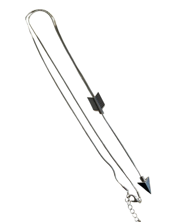 Silver necklace with arrow-shaped pendants on a light background