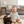 Load image into Gallery viewer, Baby sitting on a mat with a dog, both smiling, in a living room setting.
