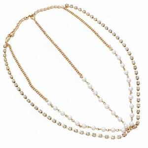 Two-layered necklace with gold chain and white beads on a white background