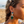 Charger l'image dans la galerie, Woman on a beach wearing turquoise earrings with a blurred background
